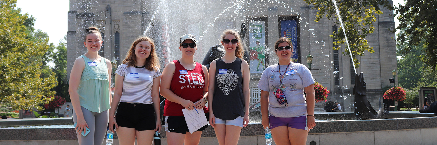 Five Women in Stem students stand in front of Showalter Fountain